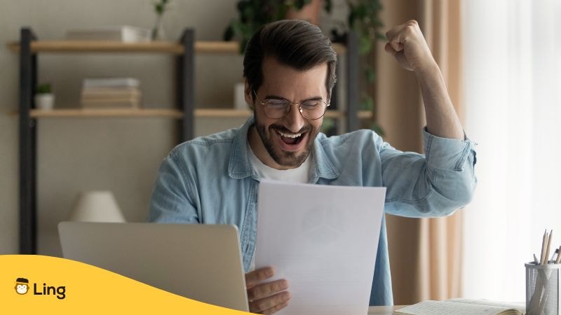 Man Celebrating While Reading A Letter