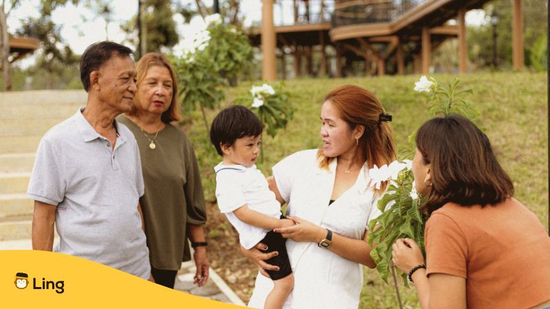 Adults In Family Teaching Young Kid About Thai Vocabulary For Family