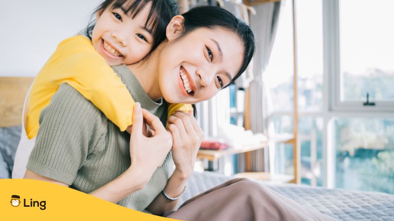 Thai Mother With Her Daughter Smiling