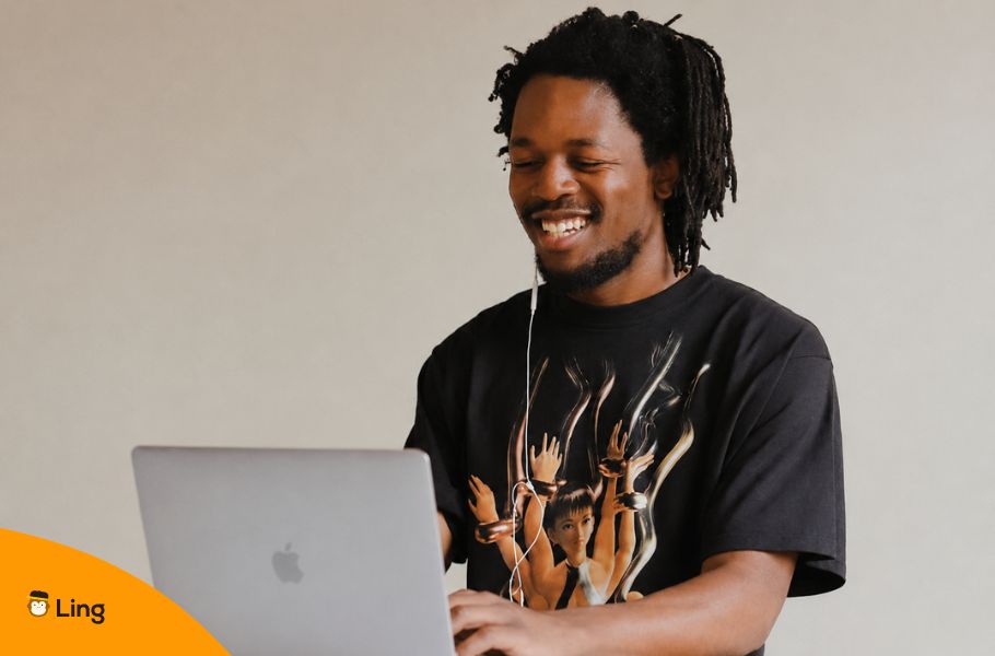 Smiling Man Working On A Laptop