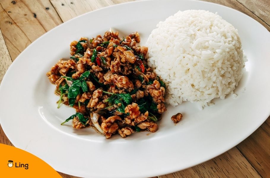 Stir Fried Thai Basil With Minced Pork And Rice On Oval Ceramic Plate