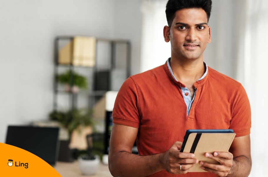 Indian Man Holding A Tablet