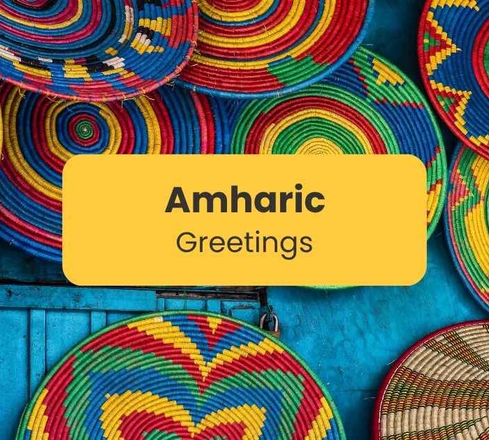 "Amharic greetings" written on a yellow text box with colorful Ethiopian baskets as background