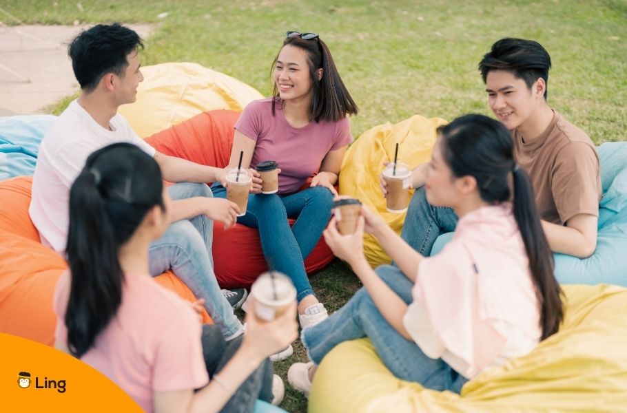 Filipino Friends Talking In Cebuano During A Picnic