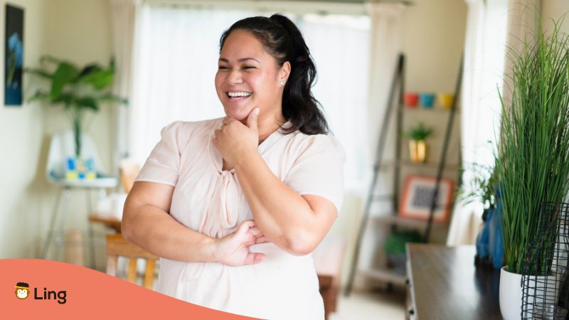 A Maori Woman At Home With A Playful Expression On Her Face