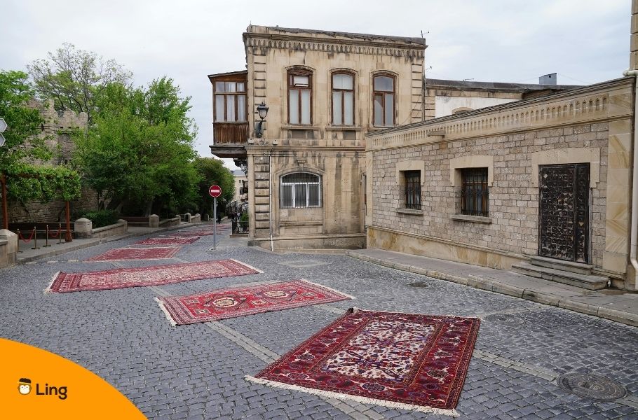 Traditional Azerbaijani Carpets On Cobblestone Street
