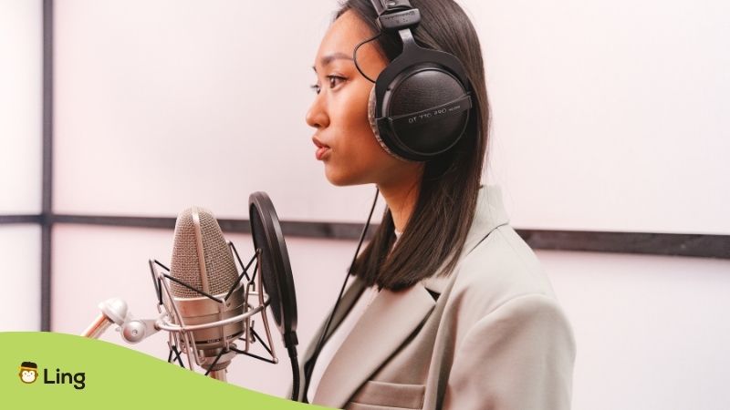 Woman Recording Audio With A Microphone And Hedphones