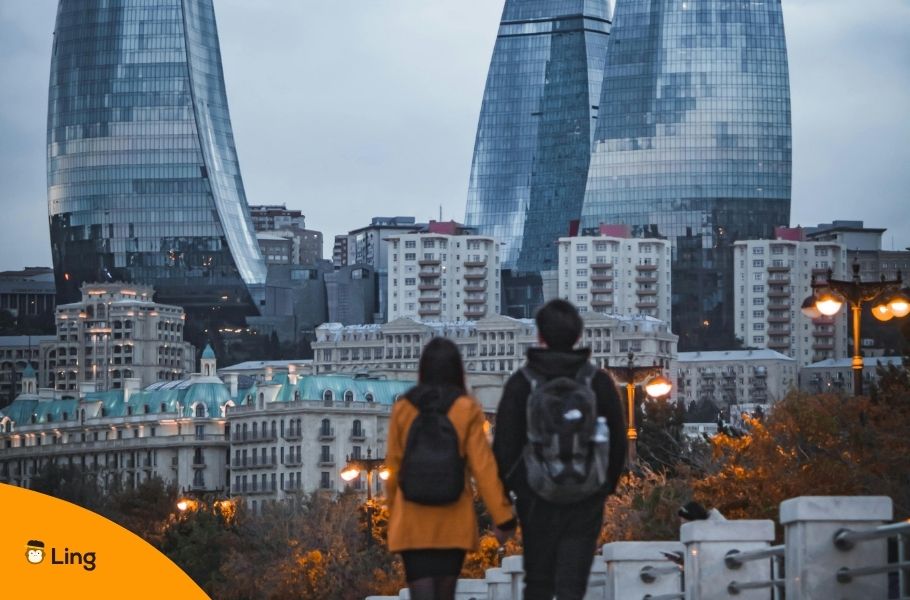 A Couple Walking In Baku, Azerbaijan, Seeing The Flame Towers