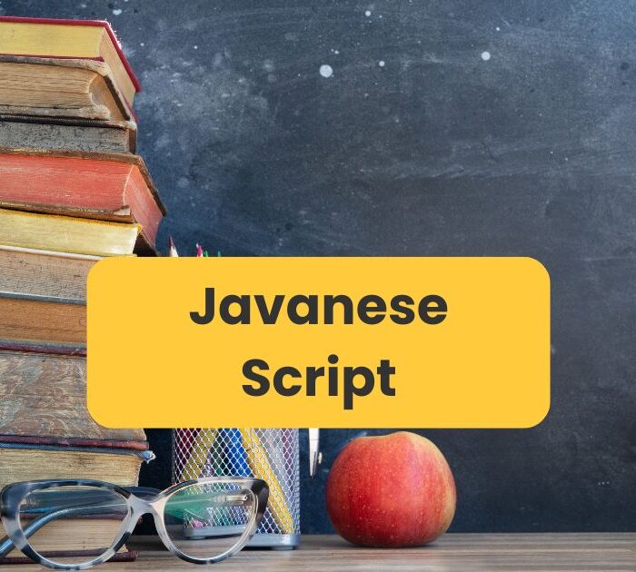 Javanese script - Old books and an apple near a blackboard