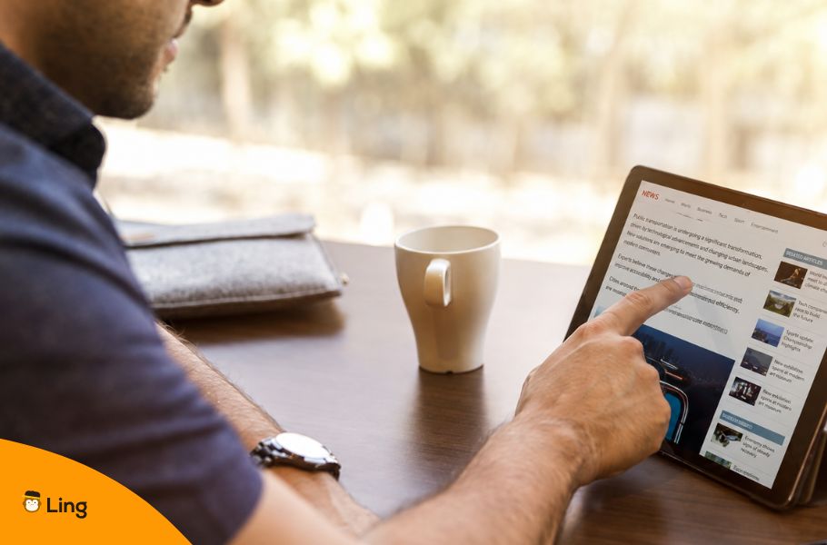 Man Reading On A Tablet