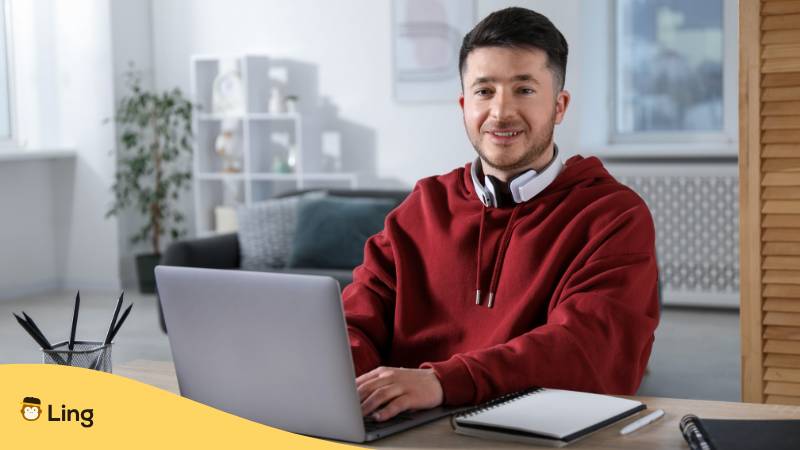 Junger Mann Mit Rotem Sweater Sitzt Motiviert Am Schreibtisch