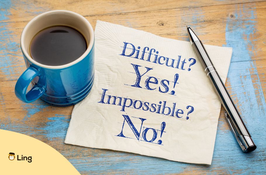 A Piece Of Paper On Which It Is Written Difficult Yes Impossible No Beside A Coffee Much And A Pen