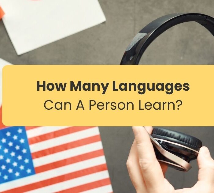 How many languages can a person learn A pair of hands holding a headset near countries flags representing languages