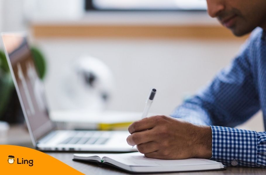 Man Studying With Laptop And Notebook
