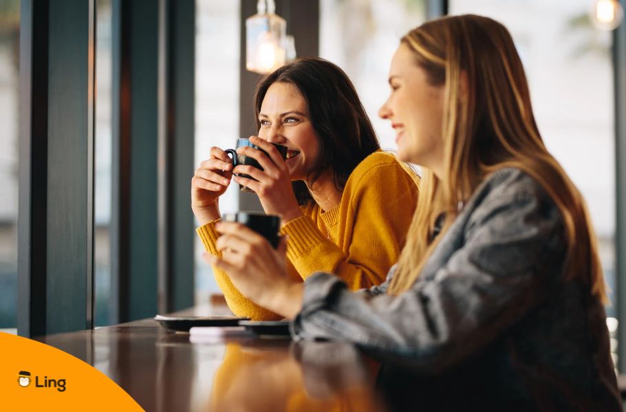 Two Women Drinking Coffee And Having A Conversation In Slovenian